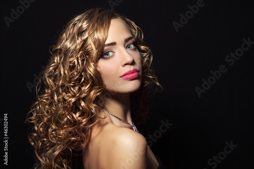 Portrait of a beautiful girl with curly hair