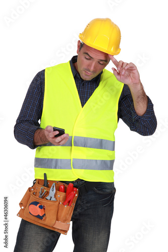 Construction worker sending text message photo