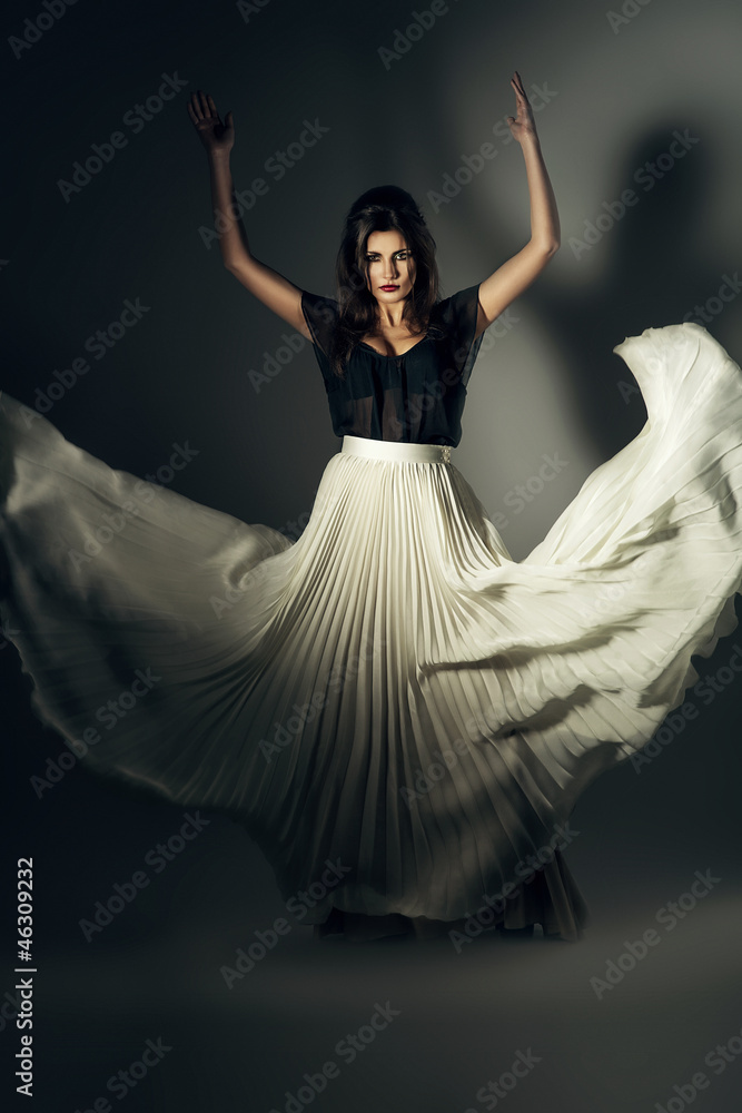 Fototapeta premium attractive woman in flying long skirt