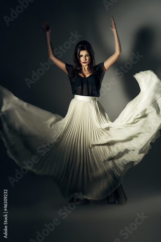 attractive woman in flying long skirt