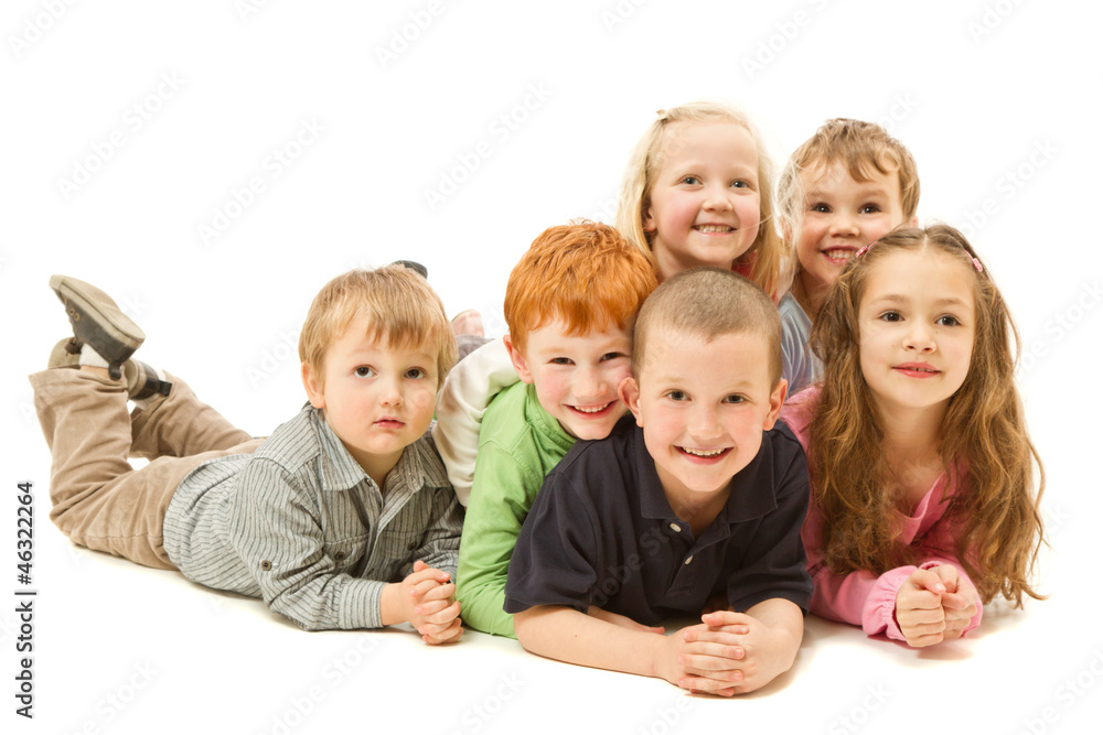Group of happy kids laying on floor together Group of happy kids laying on floor together