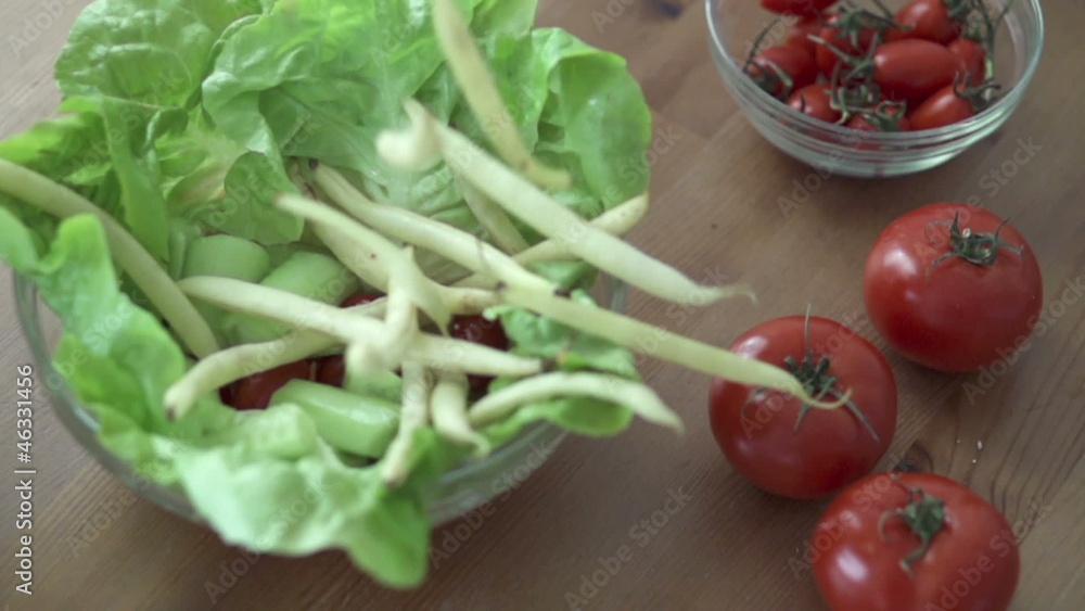 Asparagus falling into salad bowl, slow motion shot at 240fps Asparagus falling into salad bowl, slow motion shot at 240fps