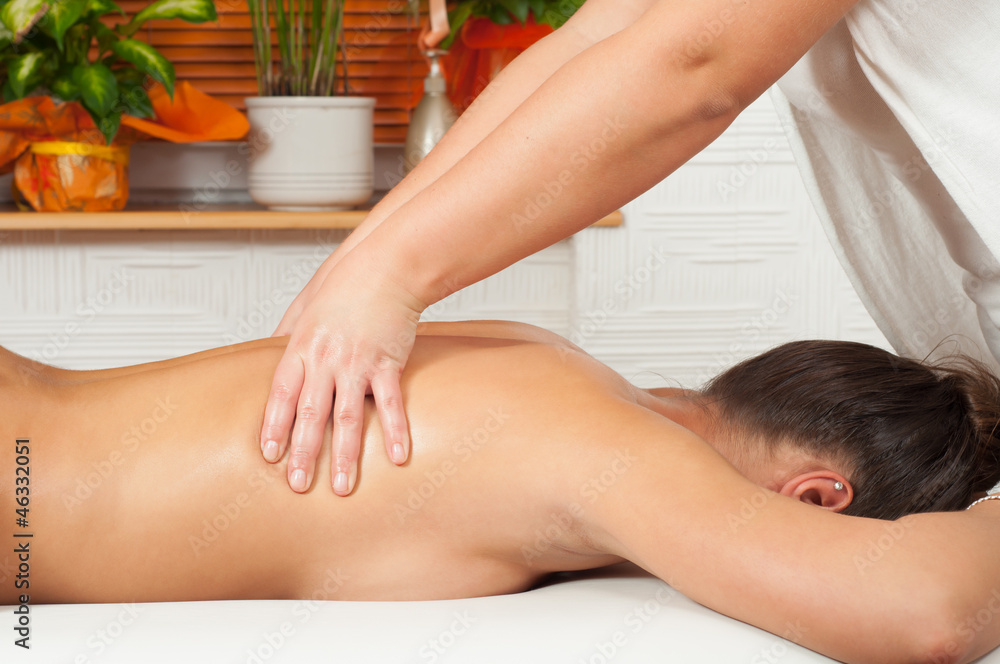 Obraz premium Young women getting back massage in massage salon