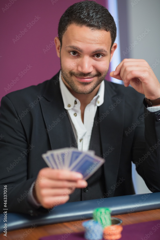 Man holding his cards Man holding his cards