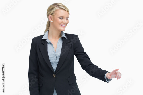 Smiling businesswoman showing something