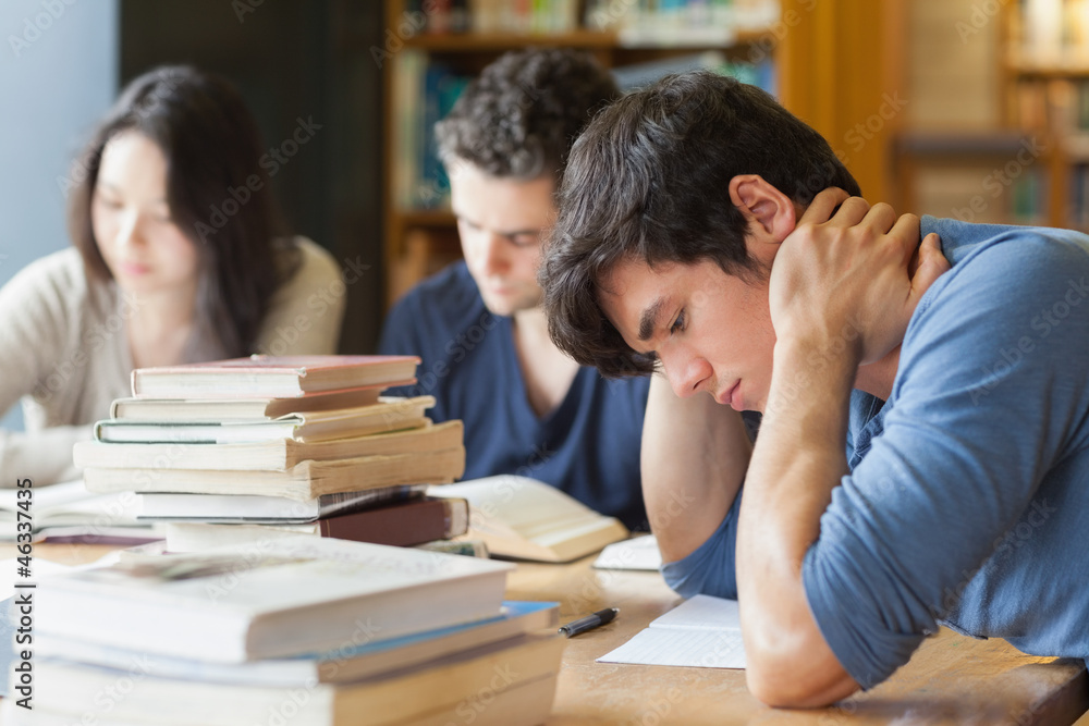 Student falling asleep in library Student falling asleep in library