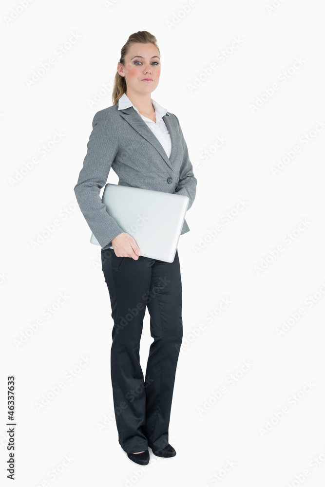 Serious businesswoman holding laptop Serious businesswoman holding laptop