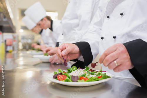 Chef garnishing salads