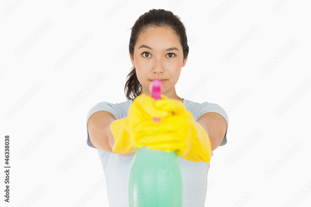 Woman pointing a spray bottle at the camera Woman pointing a spray bottle at the camera