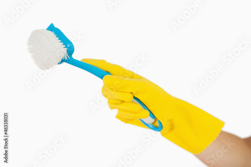 Female hand holding scrubbing brush