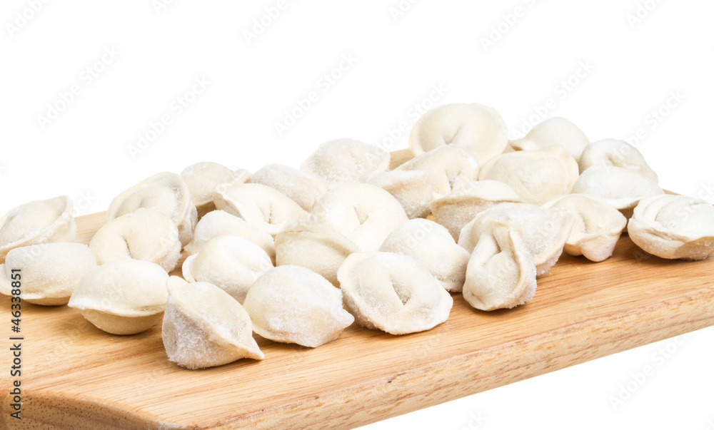 Some raw dumplings on the wooden board