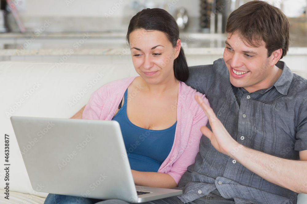 Two people using the laptop Two people using the laptop