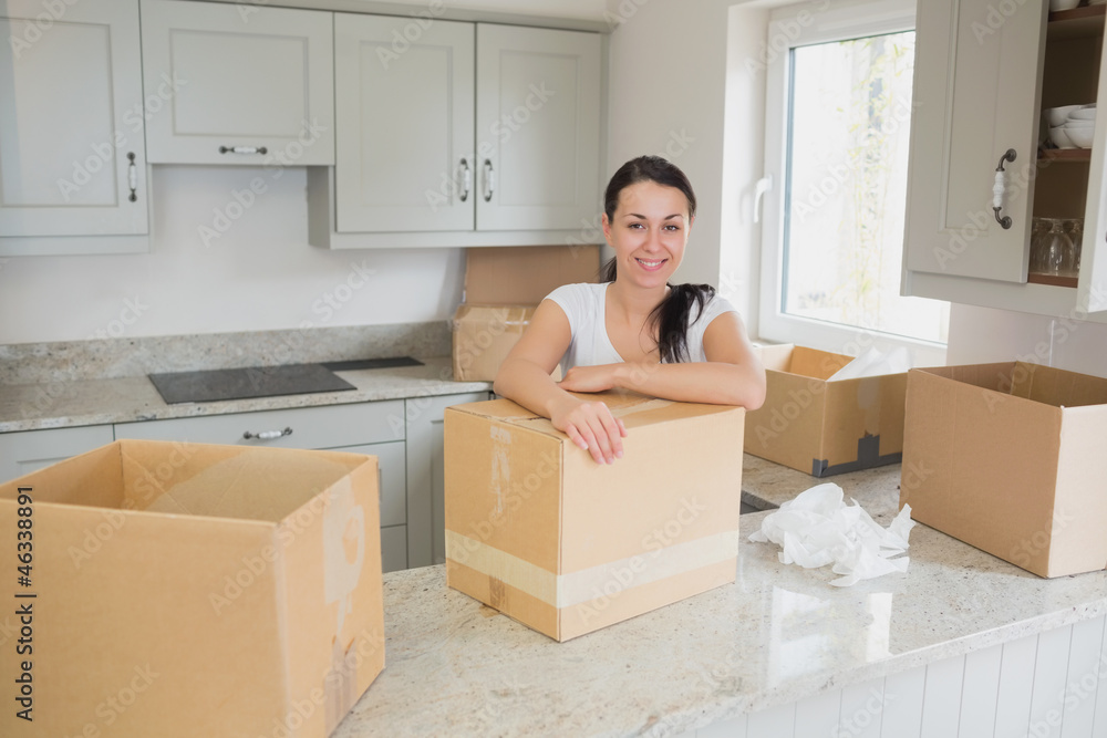 Smiling woman unpacking Smiling woman unpacking