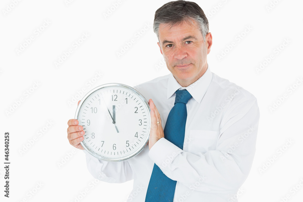 Businessman holding clock Businessman holding clock