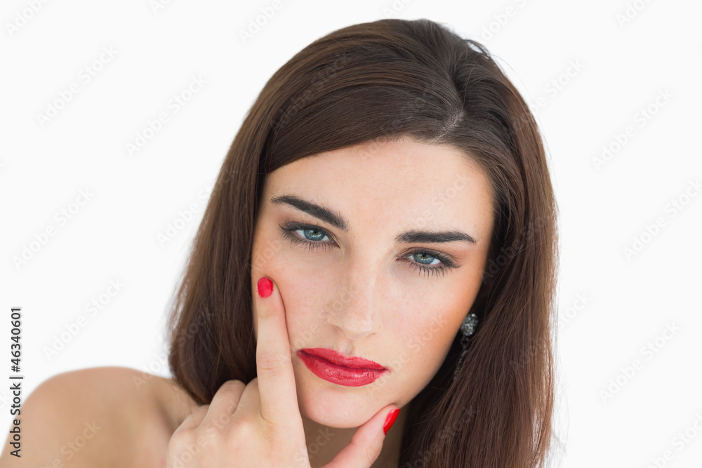 Woman touching her chin while looking at camera Woman touching her chin while looking at camera