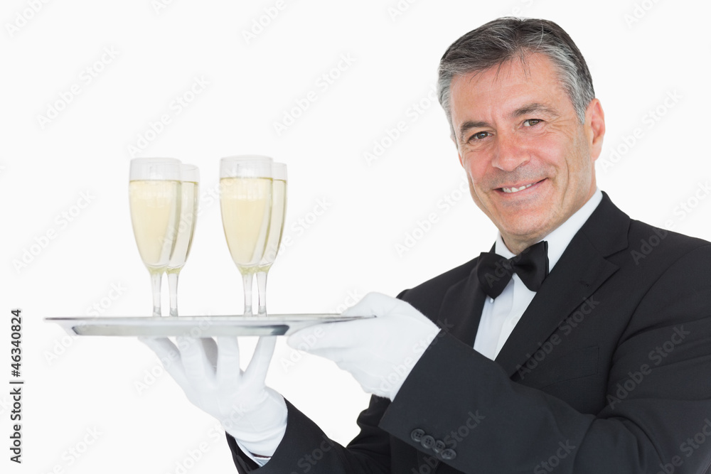 Waiter holding tray with glasses full of champagne