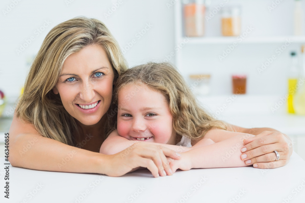 Mother and daughter resting on the table Mother and daughter resting on the table