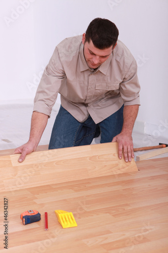 Man installing laminate flooring