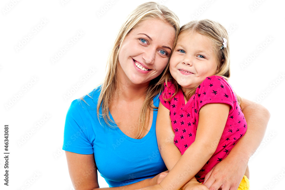 Adorable mom and daughter posing together Adorable mom and daughter posing together