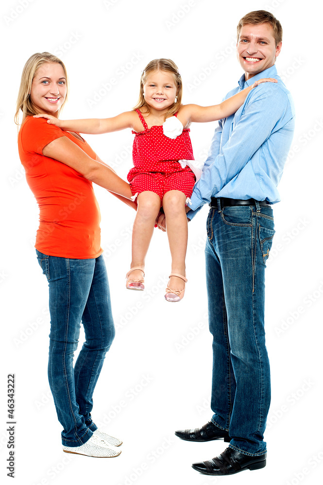 Baby girl sitting on outstretched arms of her parents Baby girl sitting on outstretched arms of her parents