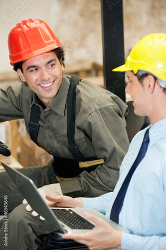 Supervisor and Forklift Driver With Laptop