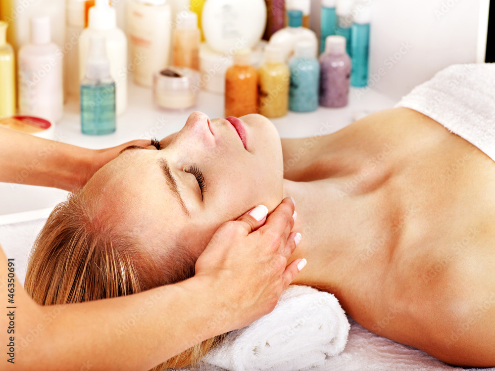 Woman getting facial massage . Woman getting facial massage .