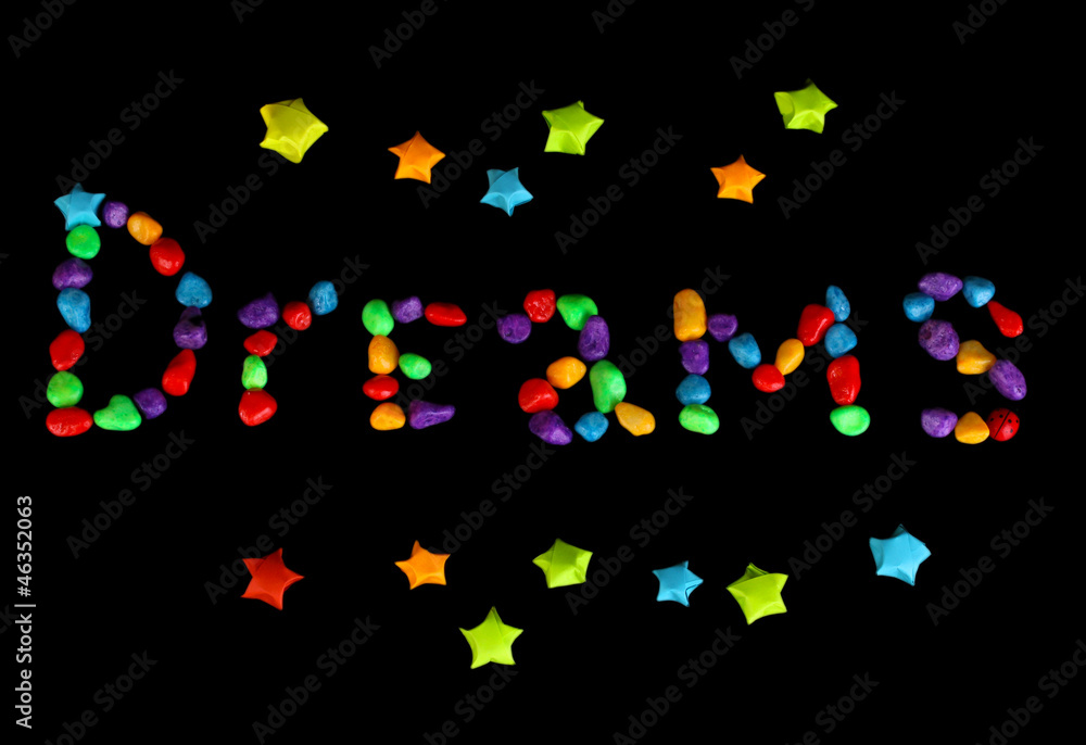 The word Dreams with colorful paper stars with dreams isolated