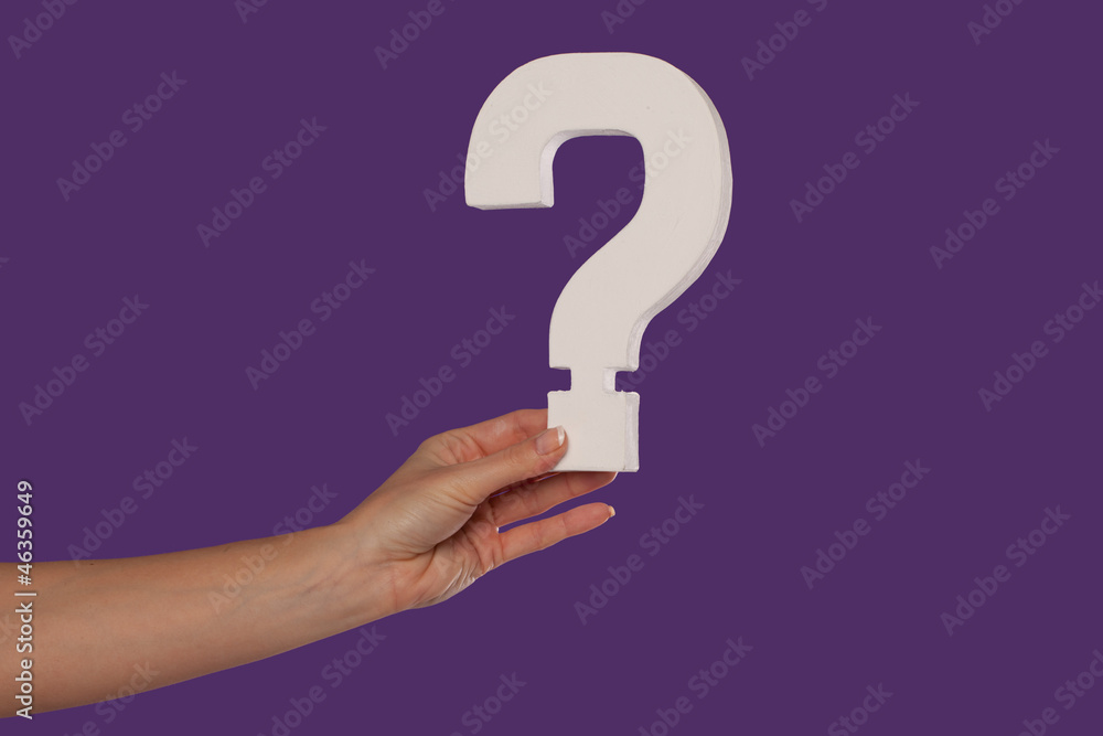 Female hand holding up a question mark from the left Female hand holding up a question mark from the left