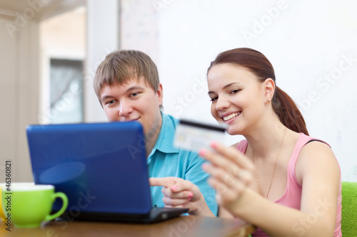 couple buying online with laptop