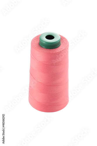 Roll of spun for sewing machine on white background.