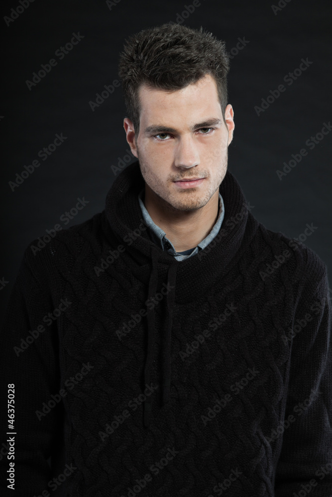 Handsome man dark winter fashion. Studio shot. Wearing sweater.