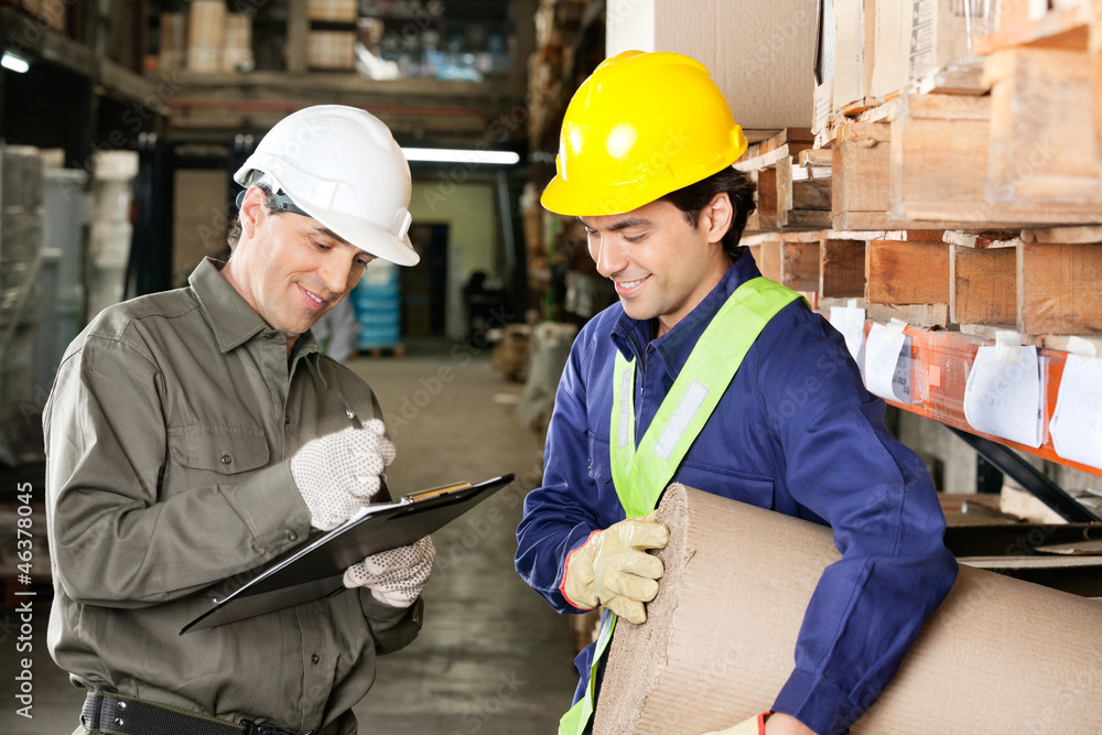 Foreman Looking At Supervisor Writing Notes Foreman Looking At Supervisor Writing Notes