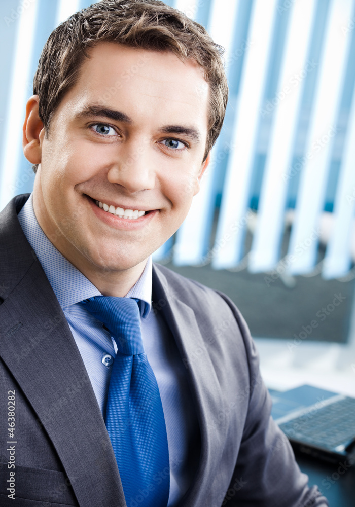 Portrait of smiling businessman at office Portrait of smiling businessman at office
