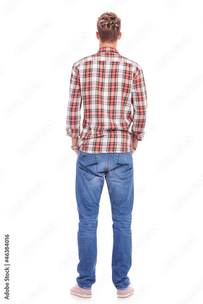 back of young man hands in pockets back of young man hands in pockets