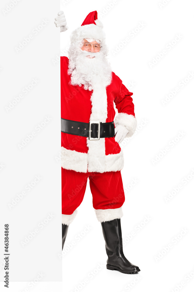 Santa Claus posing next to a blank billboard