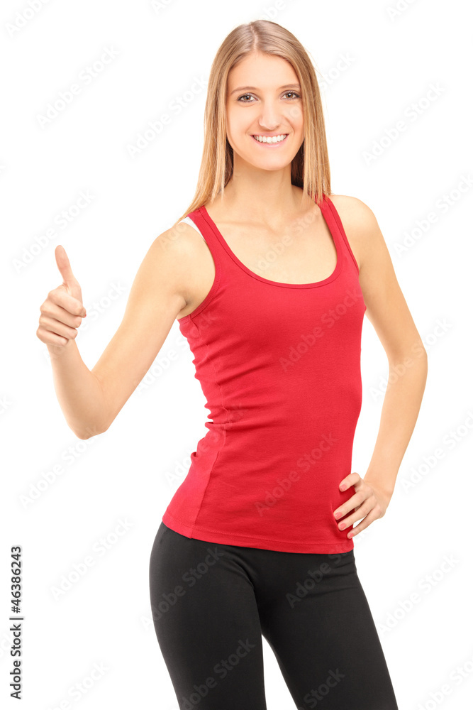Young smiling athletic female giving a thumb up Young smiling athletic female giving a thumb up