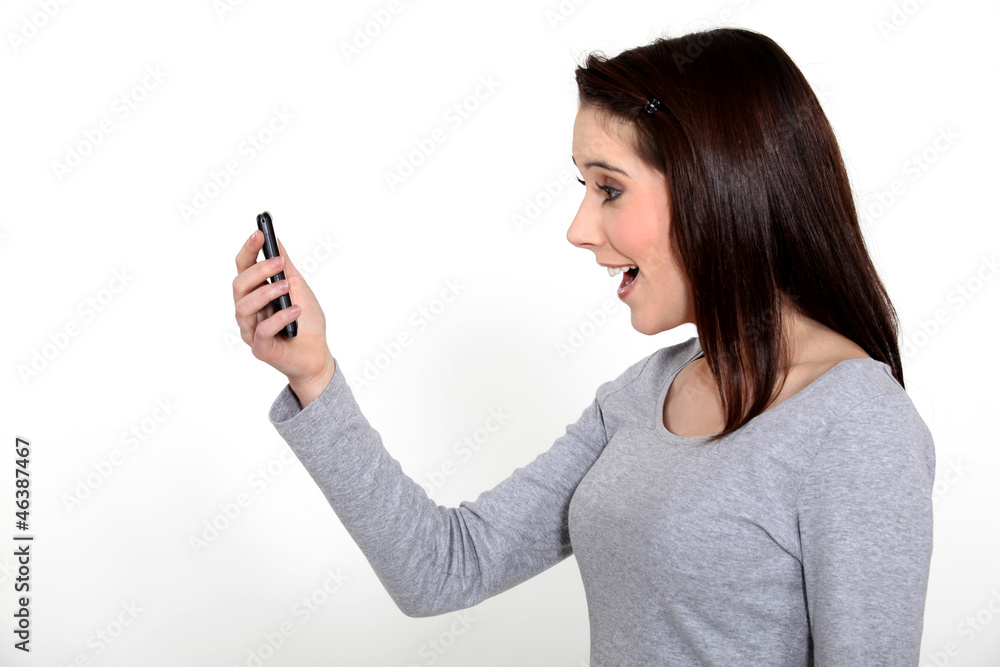 young woman receiving good news on her cell young woman receiving good news on her cell