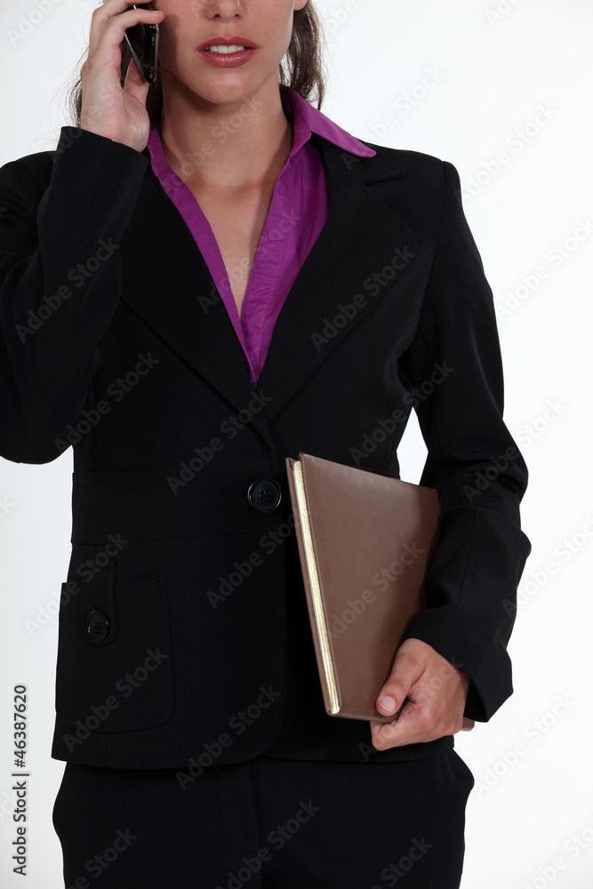 young woman on the phone holding folder young woman on the phone holding folder