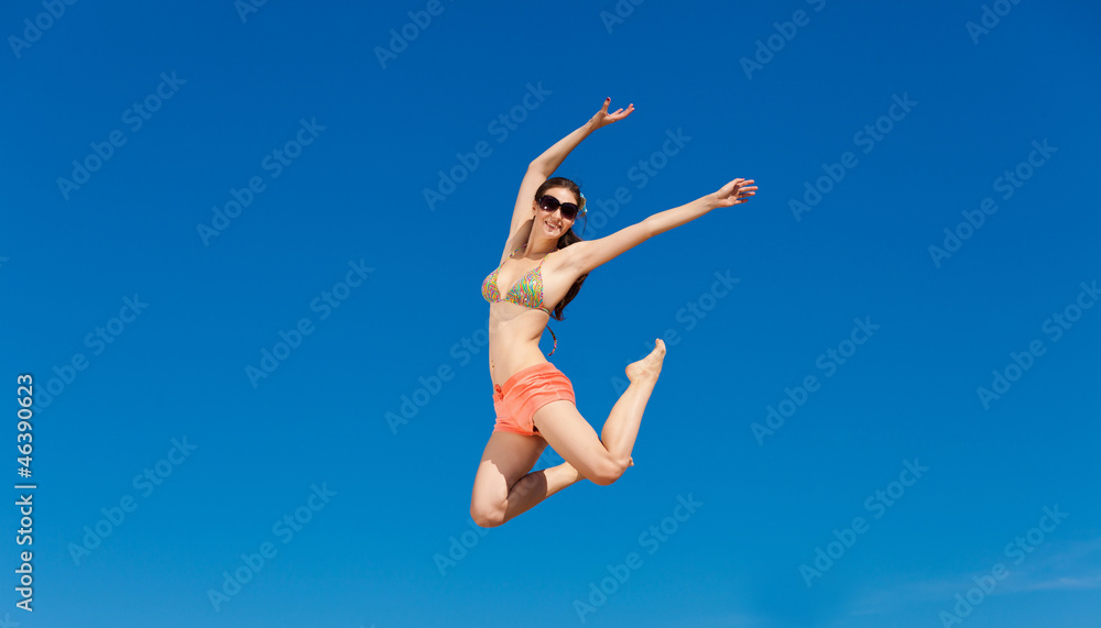 Portrait of young woman in bikini at beach