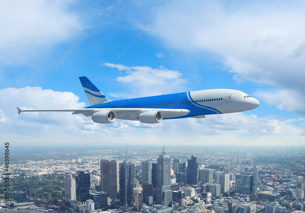 White passenger plane flying above a city White passenger plane flying above a city