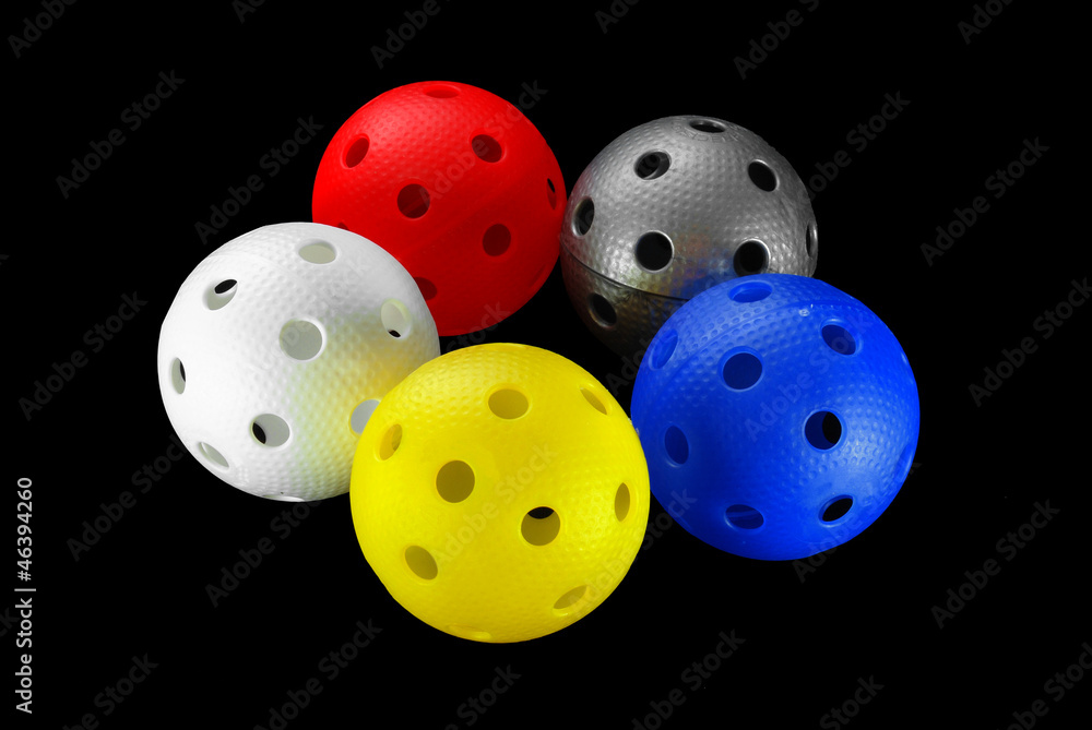 Five floorball balls isolated on a black background Five floorball balls isolated on a black background