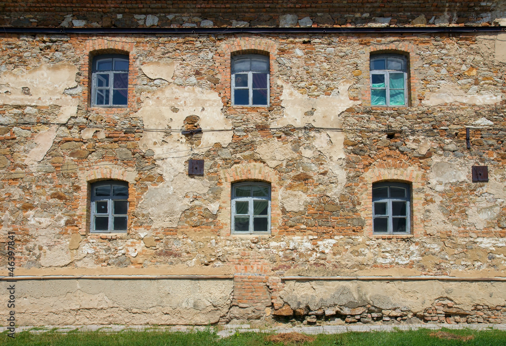 Old orange brick wall with six windows