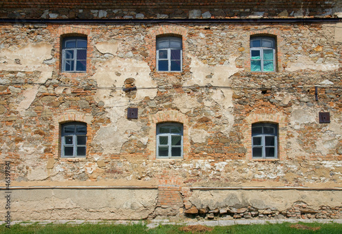 Old orange brick wall with six windows