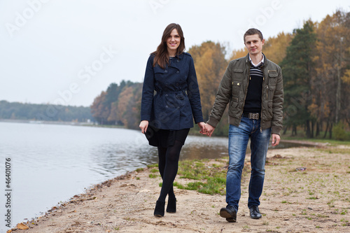 young couple walking on lake