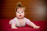 Cute funny baby girl with cheerful coiffure