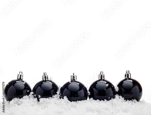 Black christmas balls with snow isolated on white bacground