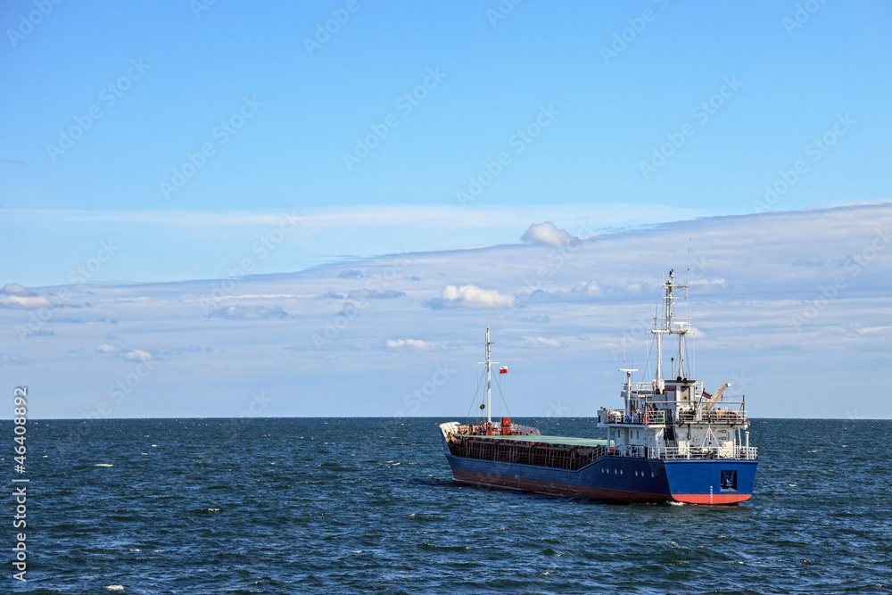 Lone cargo ship at sea