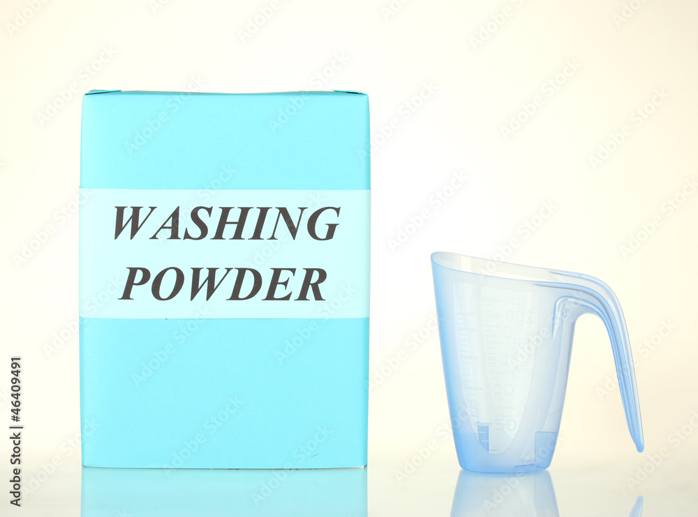 Box of washing powder with blue measuring cup isolated on white Stock Photo  | Adobe Stock