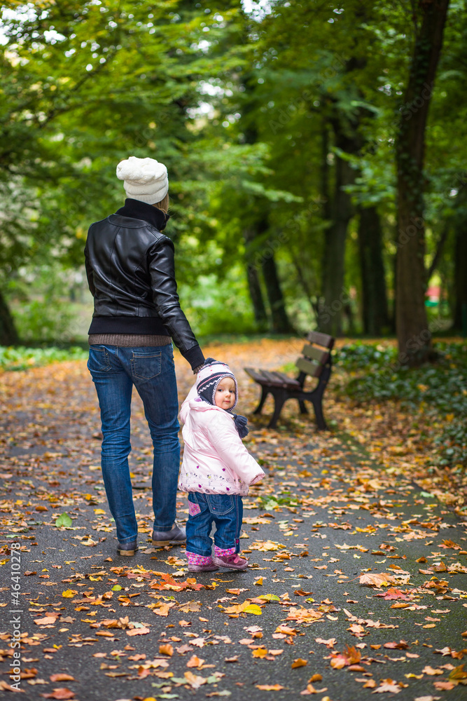 Infant baby girl in golden autumn park Infant baby girl in golden autumn park
