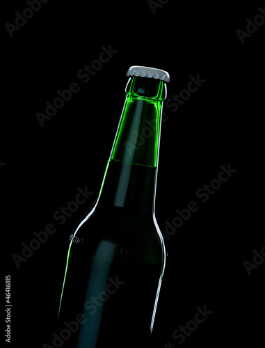 a green bottle beer over black background with shadow